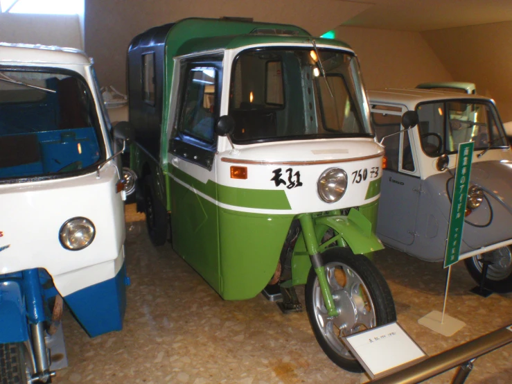 several vintage scooters parked on display in a garage