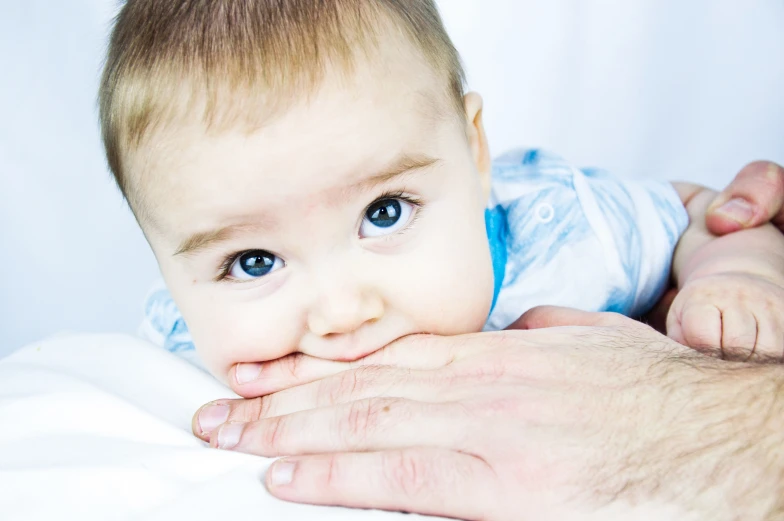 a person holding a baby on their hands