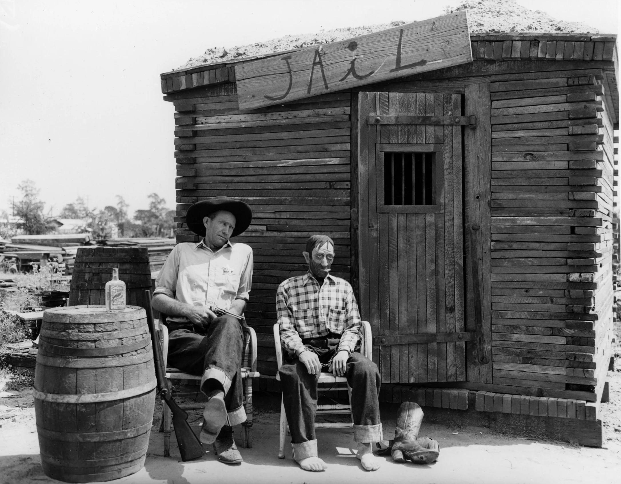 two men are sitting in chairs next to a building