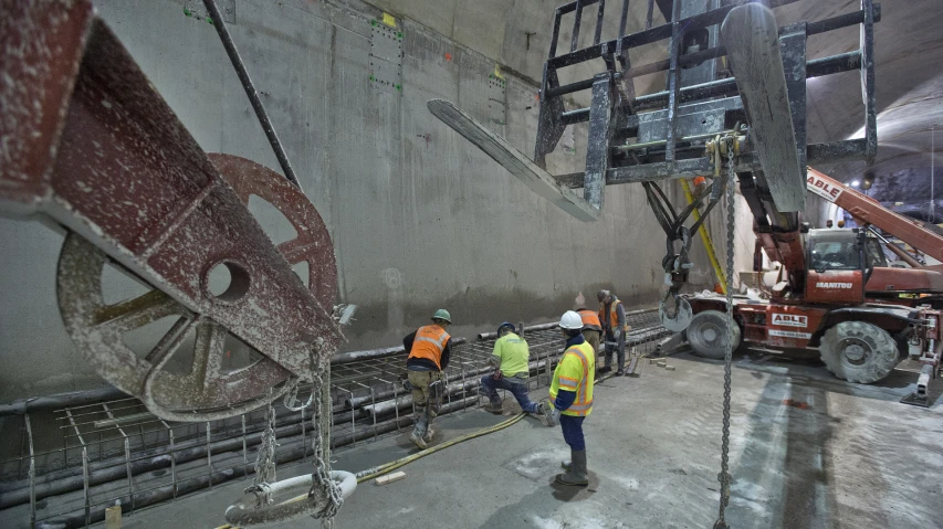 workers in safety vests and vests working on construction