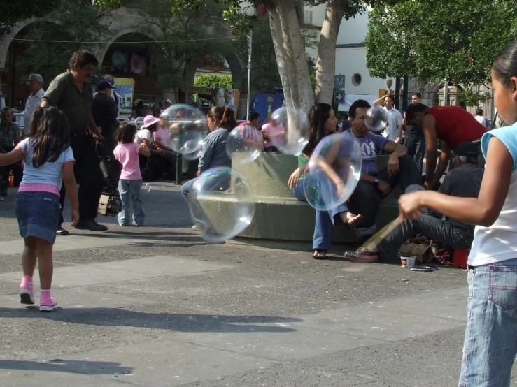 a girl is blowing bubbles with her friends