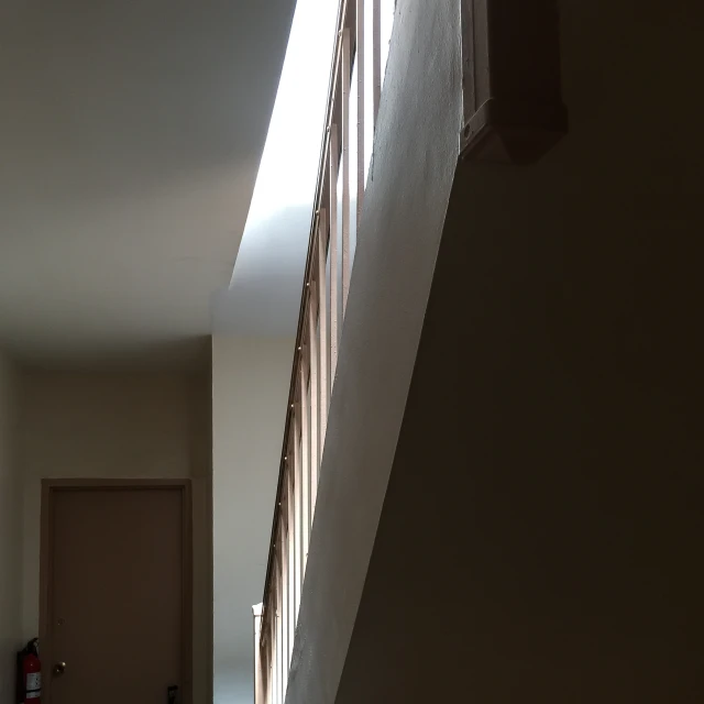 long narrow staircase with sunlight streaming through a window