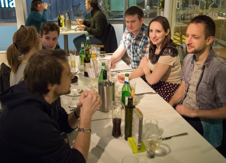 a group of people sitting at a table together