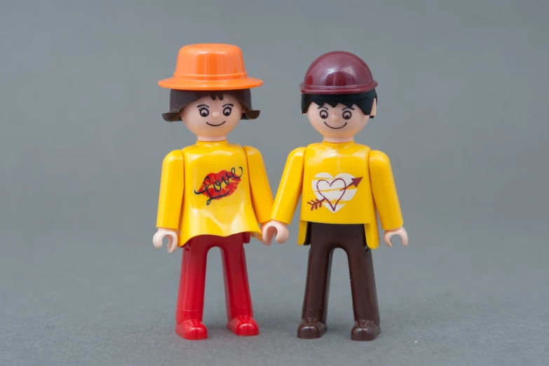 two figurines wearing construction safety gear