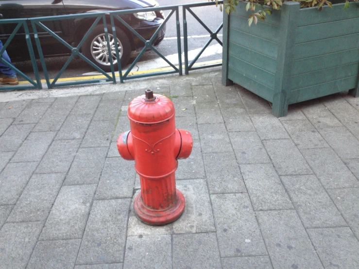 a red fire hydrant sitting on the side of a road