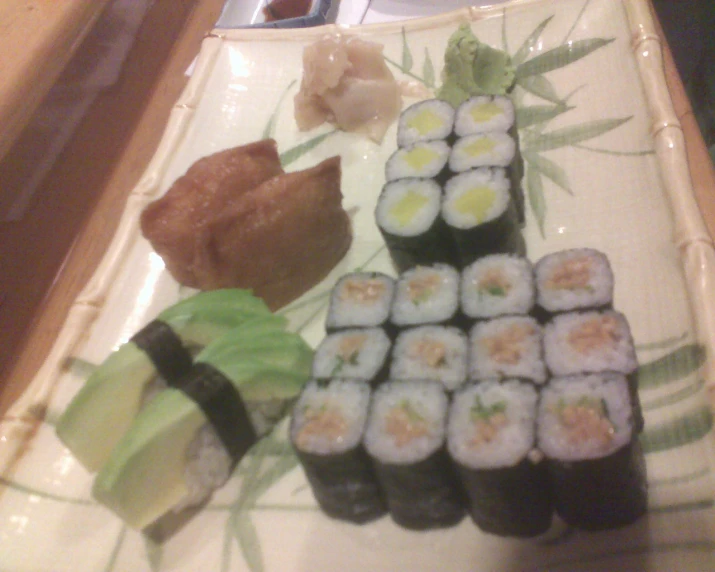 a plate full of sushi on display at a japanese restaurant