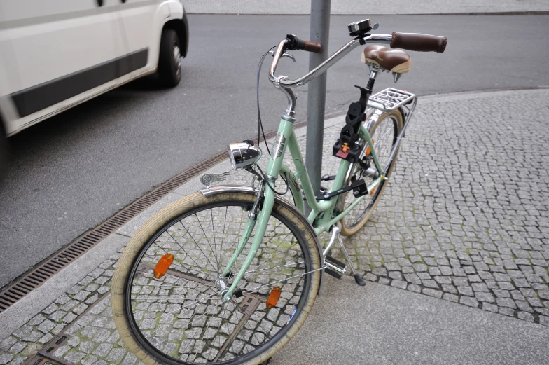 there is a bike parked by the pole