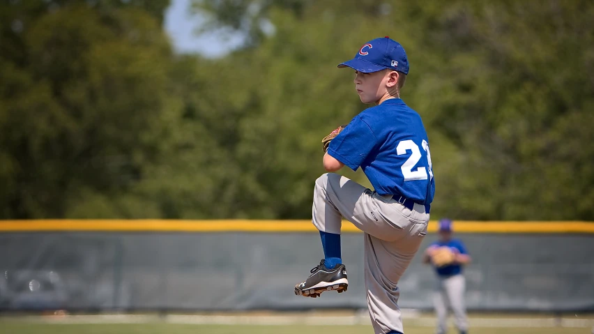a baseball player pitching a ball during a game