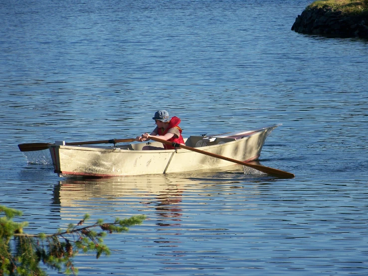a woman is rowing in her rowboat through the water