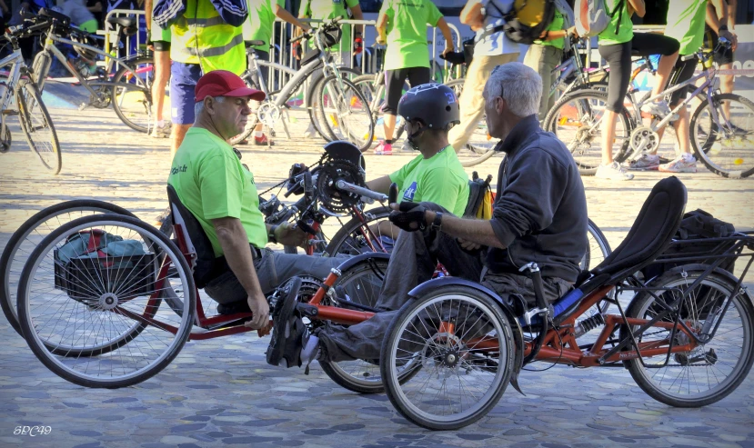 three men are sitting on different types of bikes