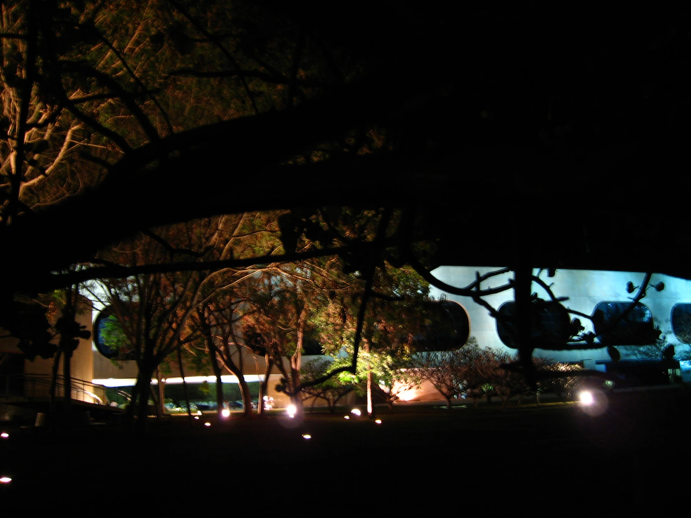 a building with several lights shining in the darkness