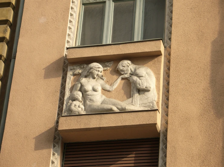 a sculpture of two people on top of a building