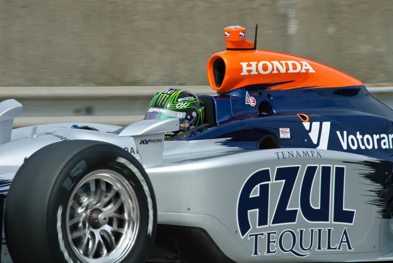 a blue and silver car is on display