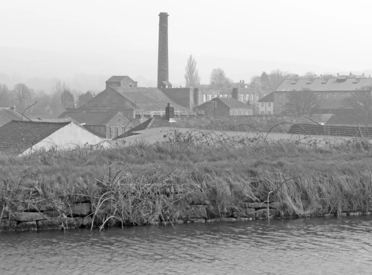 black and white po of a city, river and industrial buildings