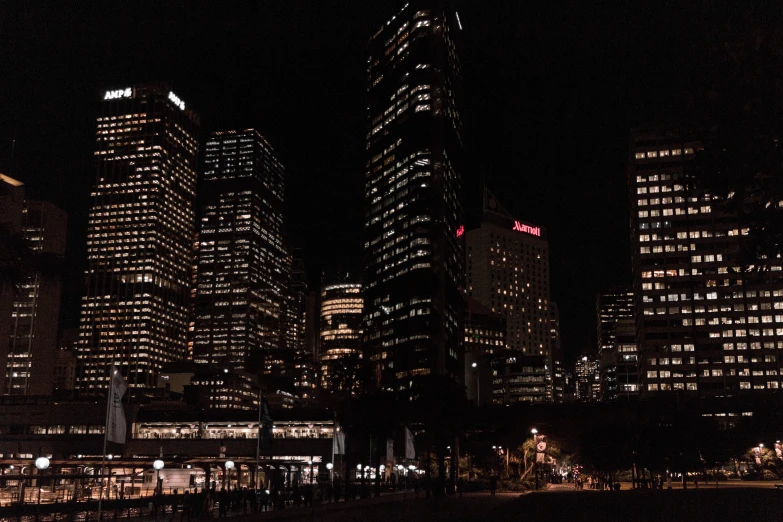 a large group of tall buildings lit up in the dark