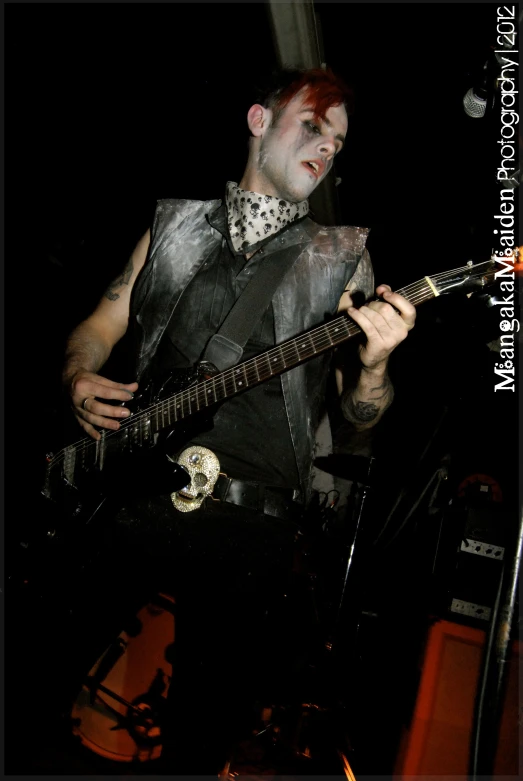 a man with red hair playing the guitar