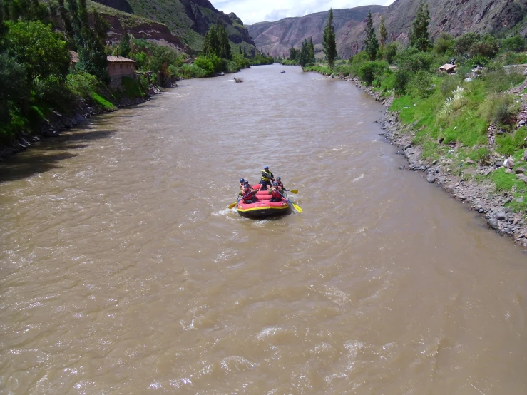 a group of people on inflatable boats ride down the river