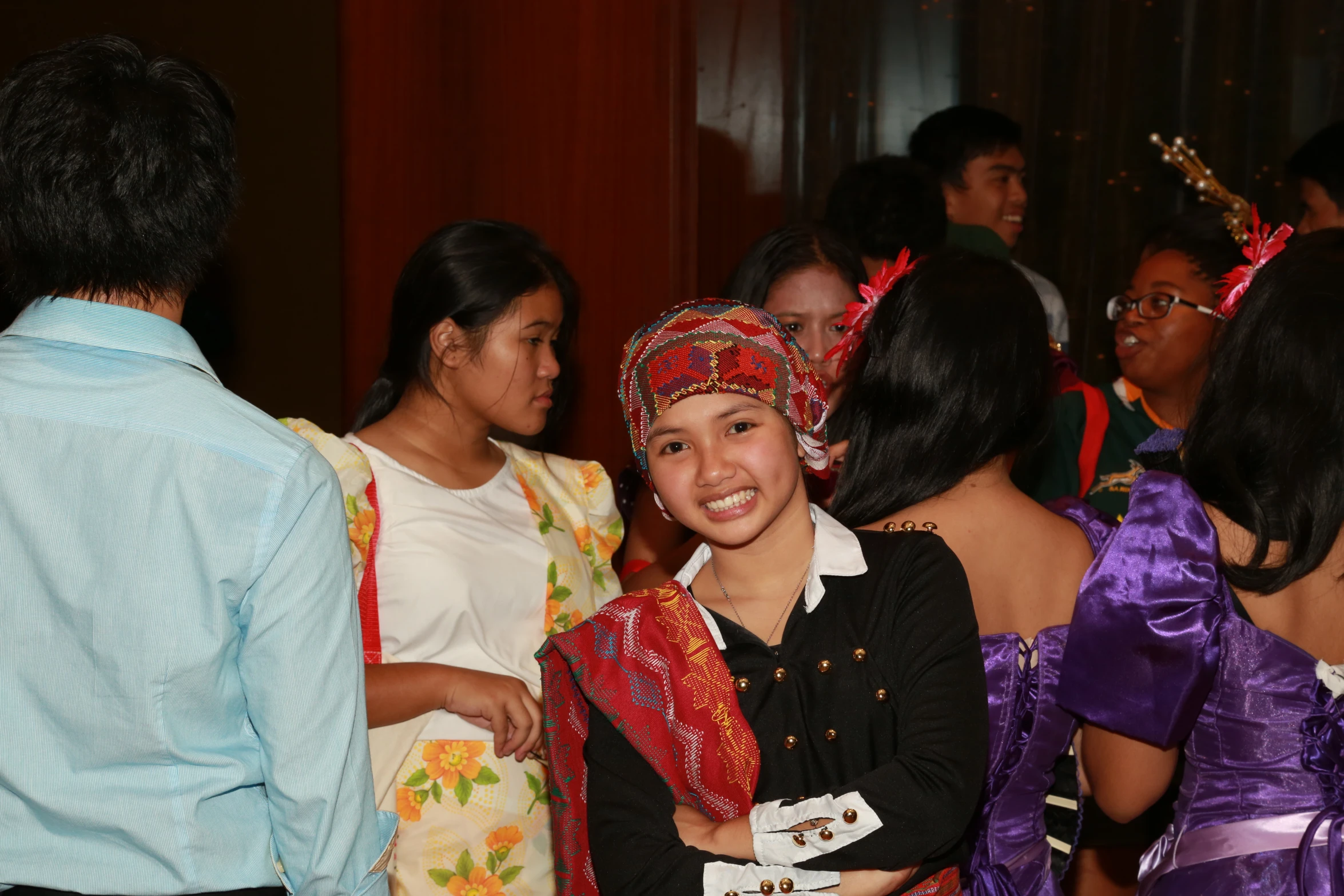 a group of women standing around each other smiling