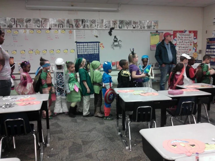 the children are all wearing different costumes in their classroom