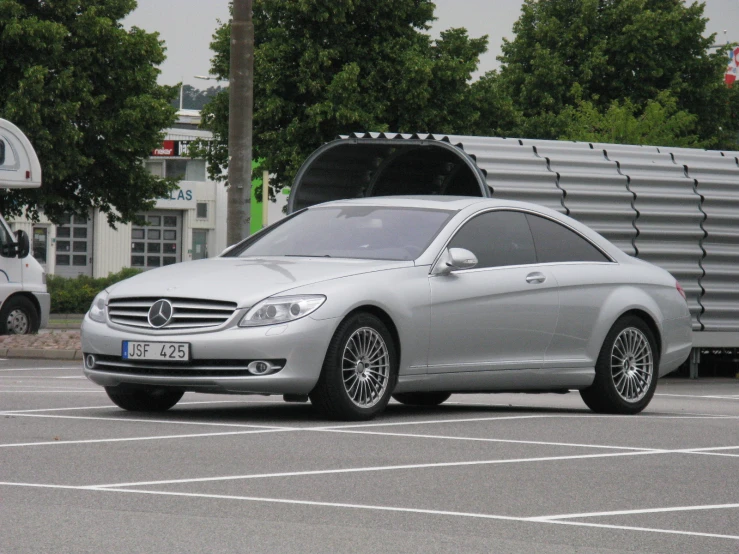 a mercedes benz s class cab in a parking lot