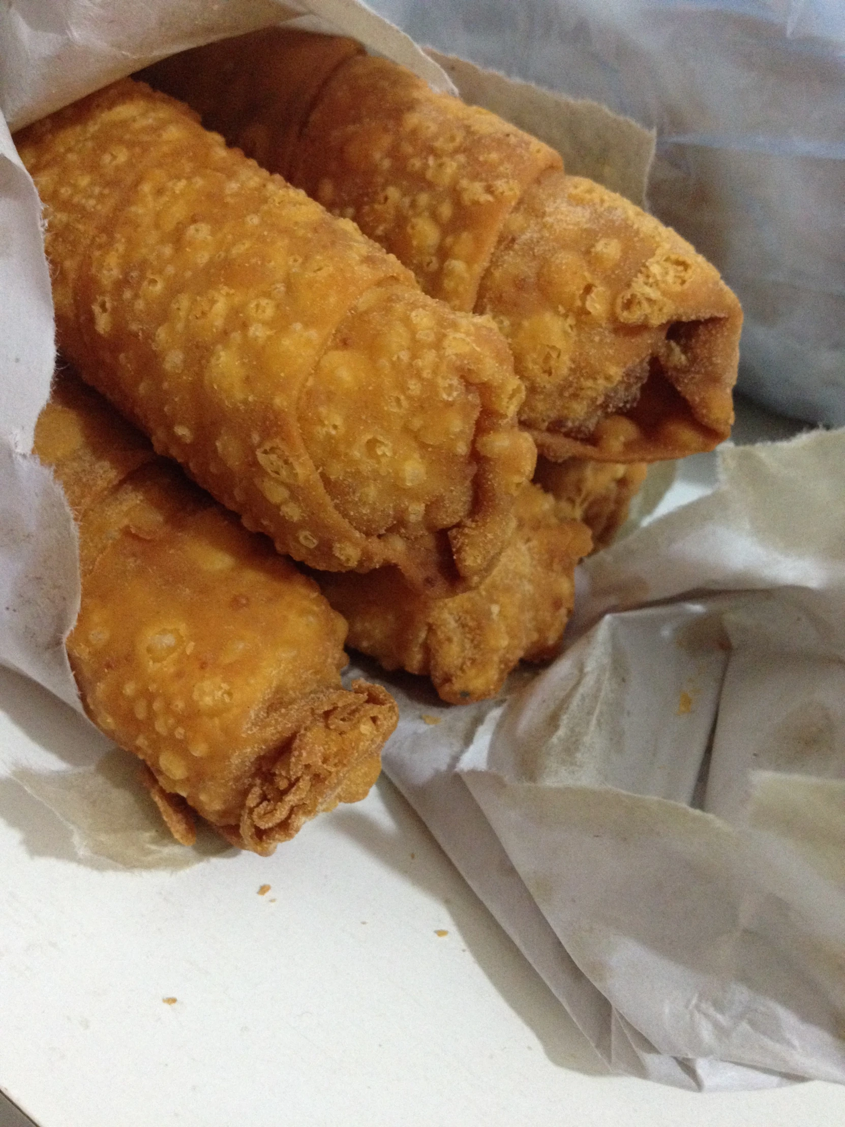 some fried food sits in a piece of parchment paper