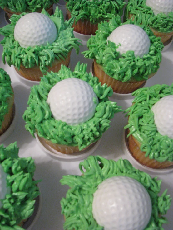 a cake shaped as a golf ball and tees
