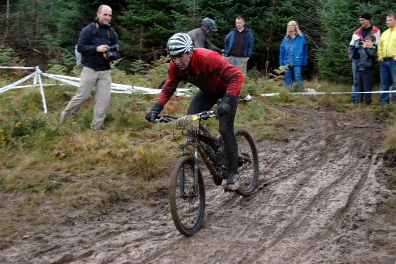 a man is riding his mountain bike through the mud