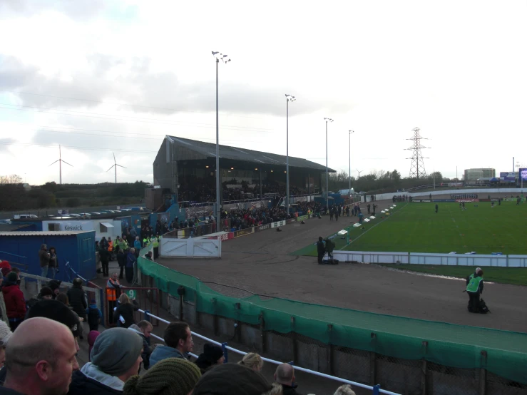 the large crowd is watching an outdoor tennis match