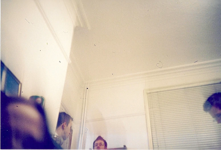 three women taking pictures in an empty room