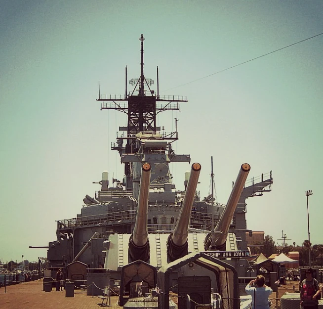 two men standing by some very big ships