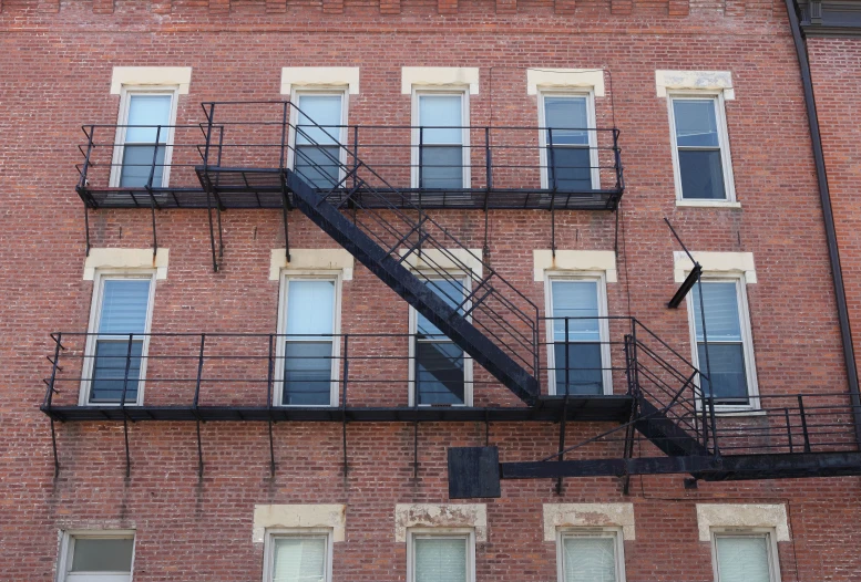 the building has many windows and stairs on the outside