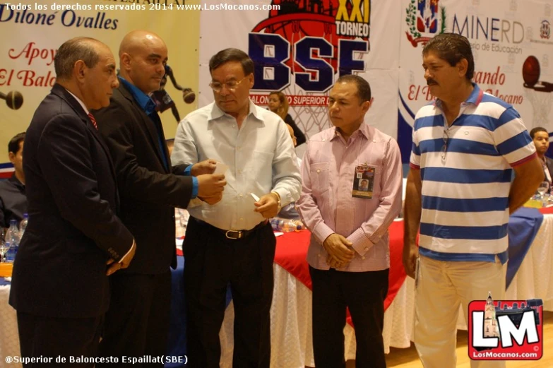 several men in striped shirts and ties shaking hands