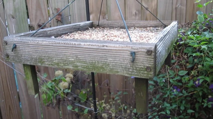 a wooden trough with a lot of dirt in it