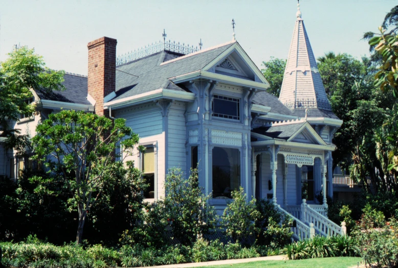 an ornate home with a steeple and dorme roof