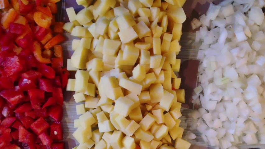 sliced and diced vegetables in different plastic trays