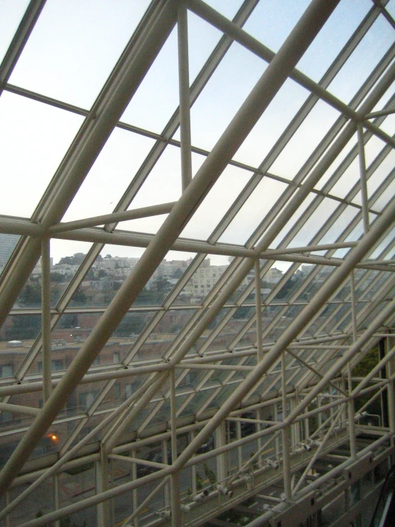 metal structures in an outdoor park setting with a city behind them