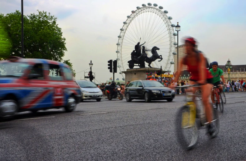 a man rides his bike through the street near traffic