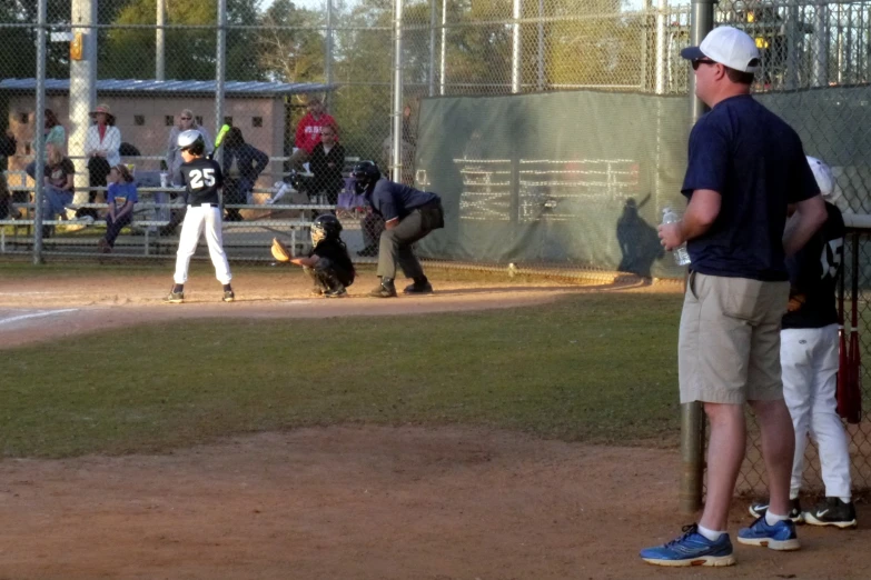 a  is standing at home plate in a baseball field