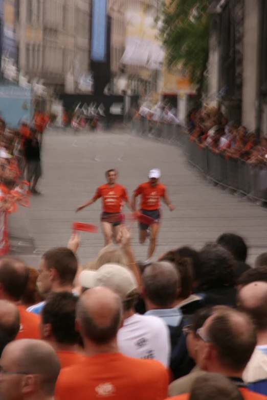 the runners are coming up the street from the stadium