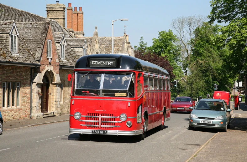 there is a bus parked along a street and cars