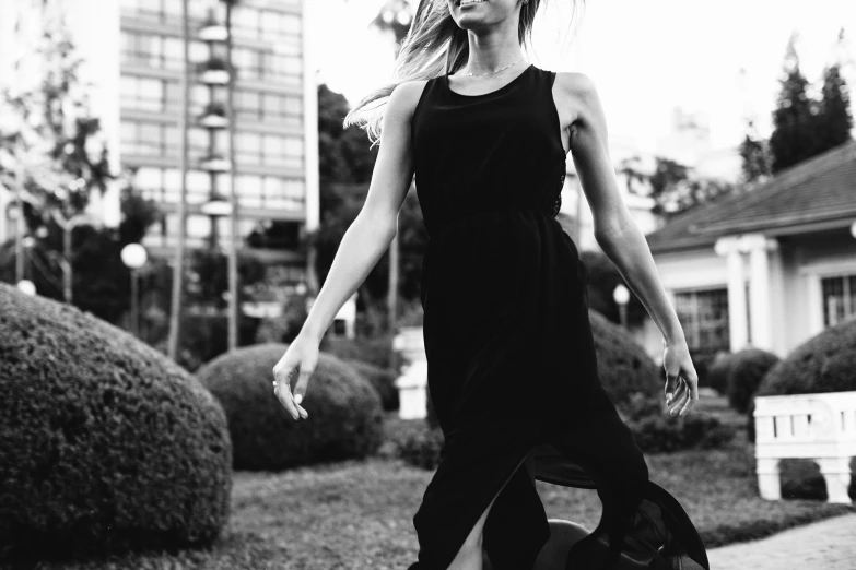 a girl standing on top of a black and white po