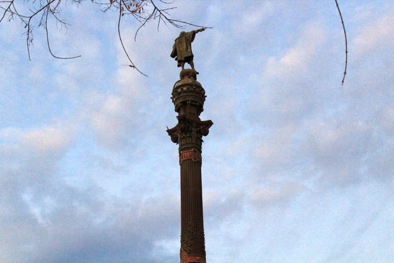 a statue that is standing next to a street light