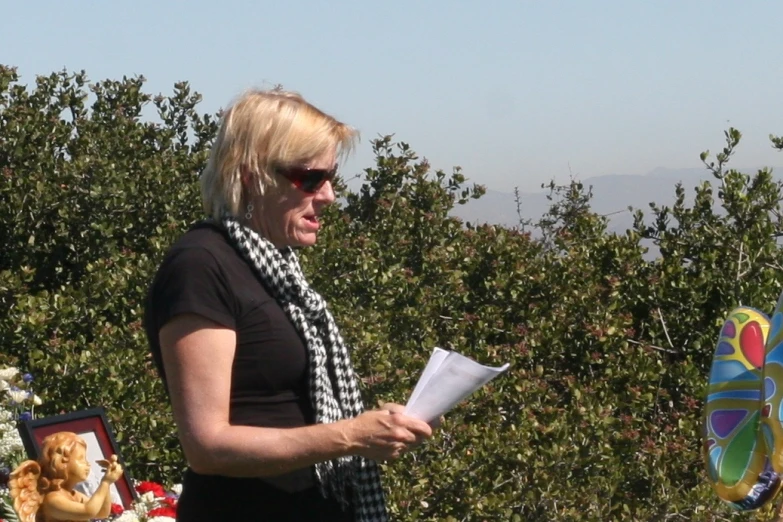 a woman holding papers on her left side