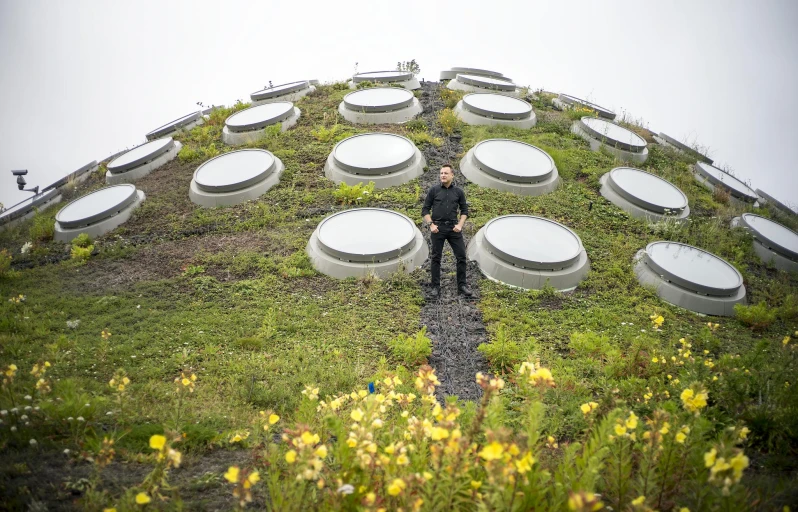 man standing in front of a green roof