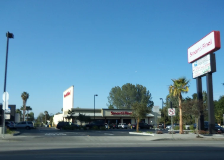 a parking lot with a few cars parked next to a building