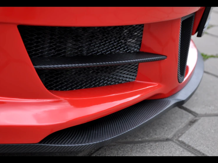 a closeup of the front of a red sports car