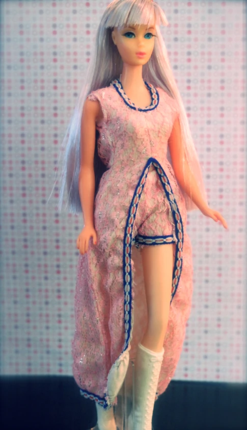this is a barbie doll with a pink dress and hair