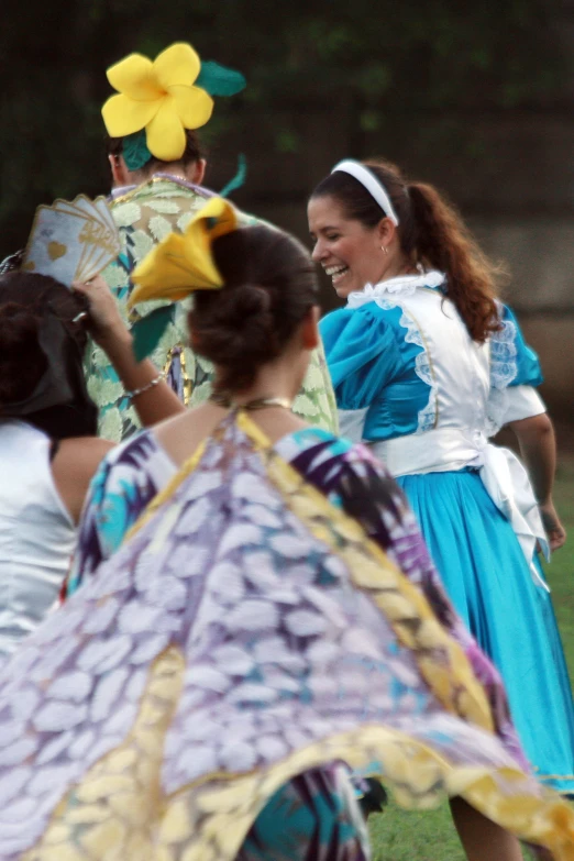 women dressed in dresses and holding up umbrellas