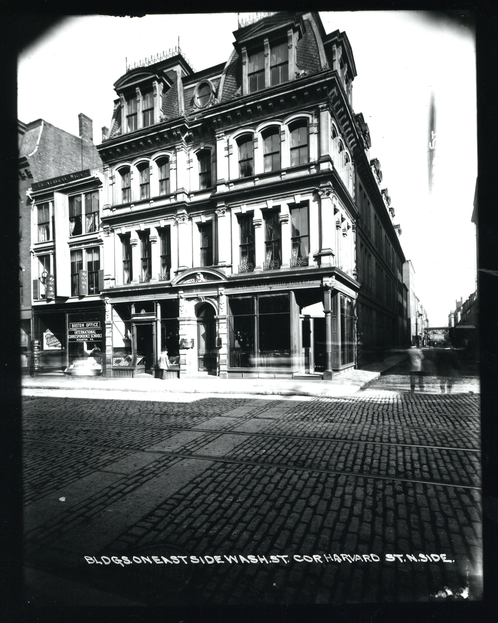 an old pograph of an old historic building on a cobblestone street