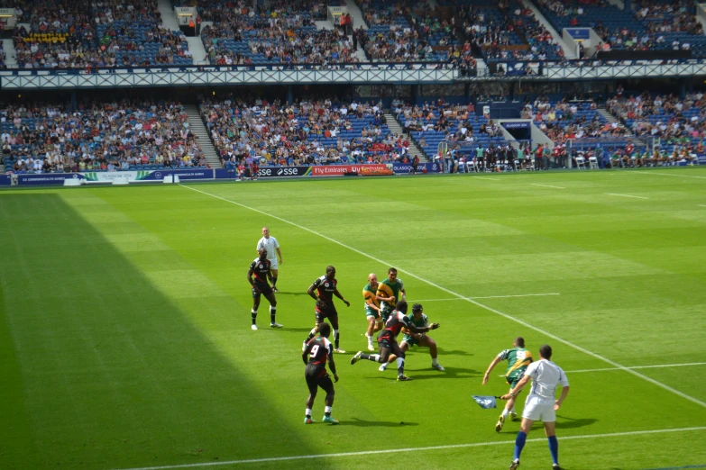 men playing a game of soccer in a large stadium